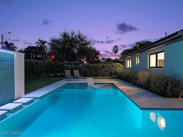 view of pool at dusk