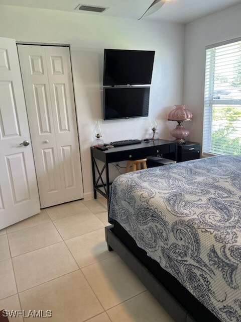 bedroom with visible vents, a closet, and tile patterned floors