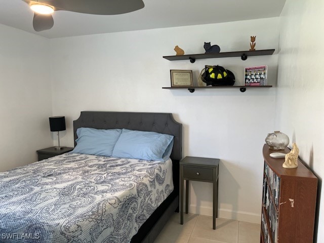 bedroom with baseboards, a ceiling fan, and tile patterned floors