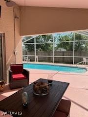 pool with a lanai and a patio