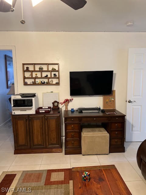 home office with light tile patterned floors and ceiling fan