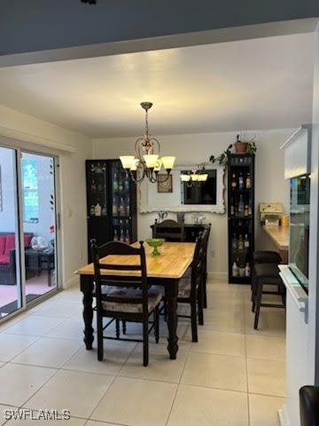 dining area with light tile patterned flooring and a notable chandelier