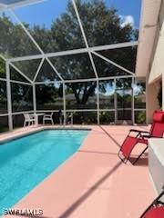 pool featuring a lanai and a patio area