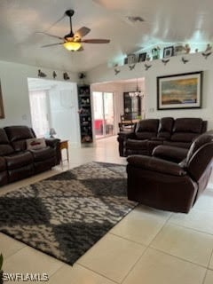 tiled living area featuring ceiling fan, visible vents, and vaulted ceiling