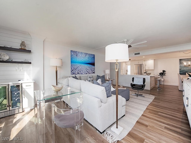 living room with ceiling fan, wine cooler, and hardwood / wood-style floors