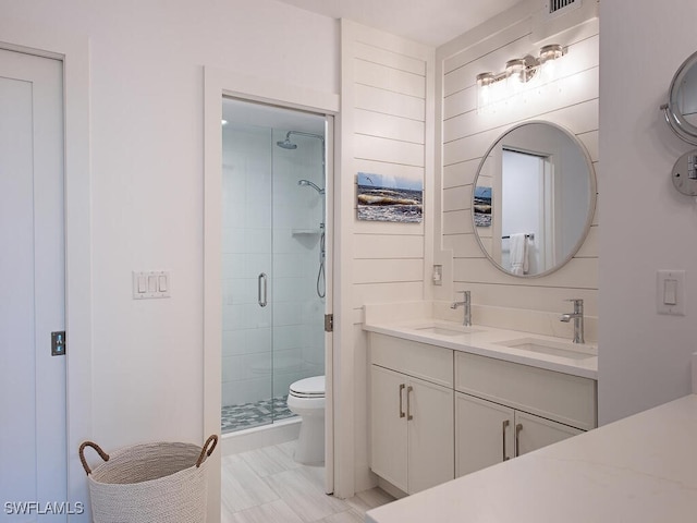 bathroom with walk in shower, vanity, and toilet