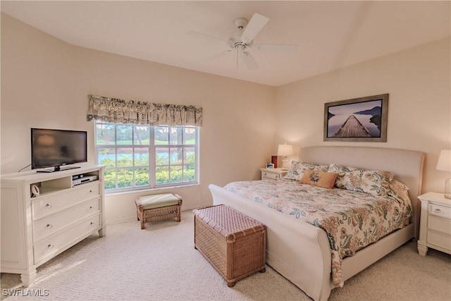 bedroom featuring baseboards, a ceiling fan, and light colored carpet
