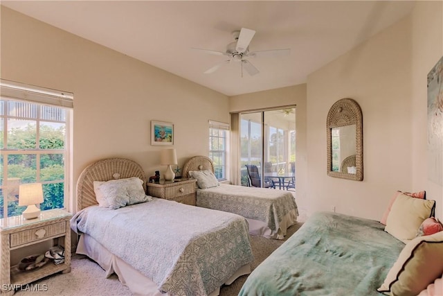 carpeted bedroom with ceiling fan and access to outside