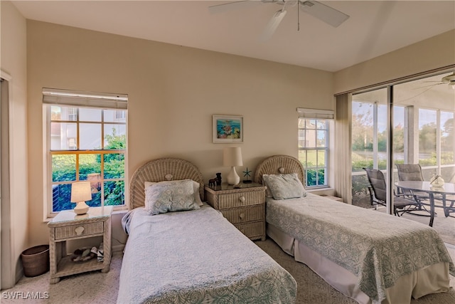 carpeted bedroom featuring access to exterior, multiple windows, and ceiling fan