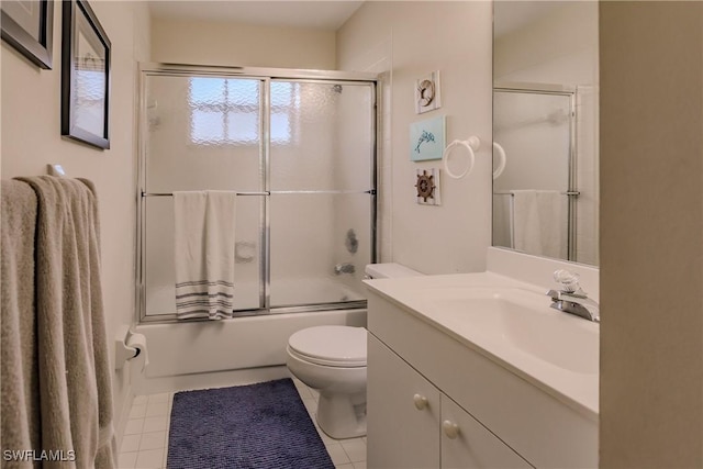 full bathroom featuring tile patterned floors, vanity, enclosed tub / shower combo, and toilet