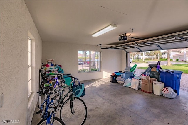 garage with a textured wall and a garage door opener