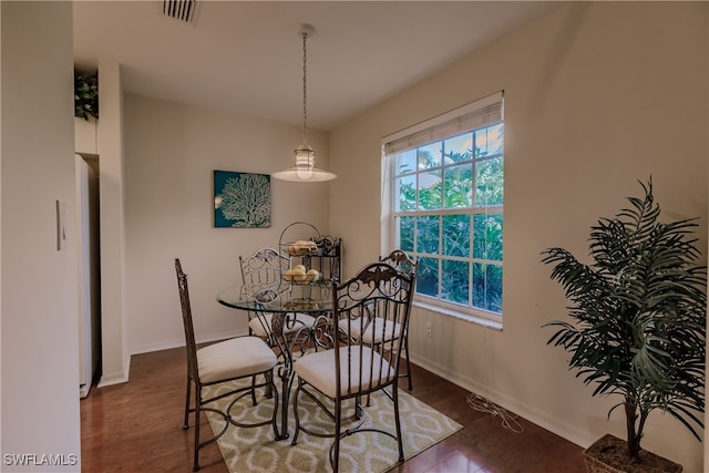 dining space with dark hardwood / wood-style floors