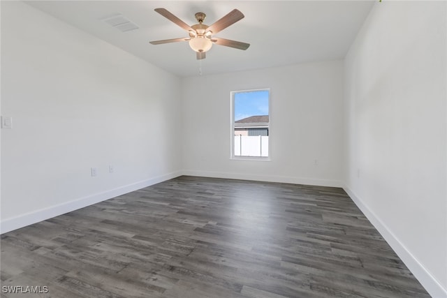 empty room with dark hardwood / wood-style floors and ceiling fan