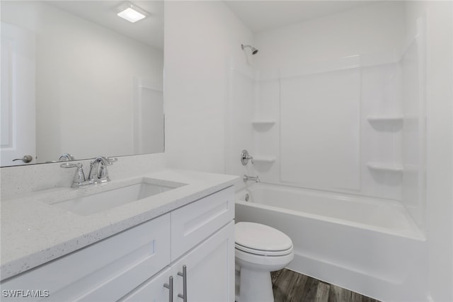 full bathroom featuring hardwood / wood-style floors, vanity, shower / tub combination, and toilet