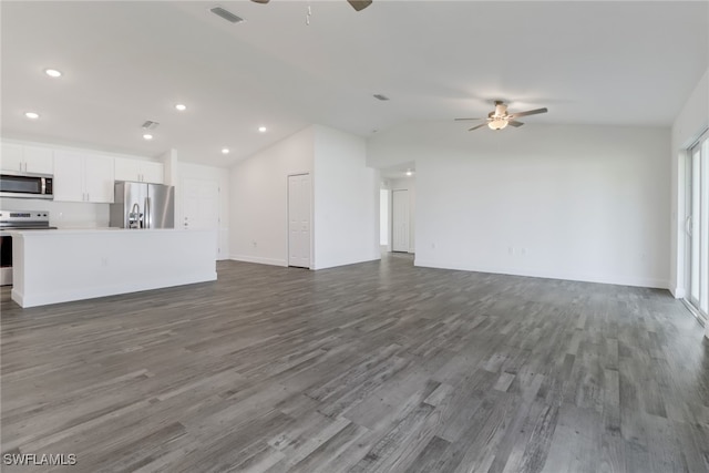 unfurnished living room featuring vaulted ceiling, hardwood / wood-style flooring, and ceiling fan