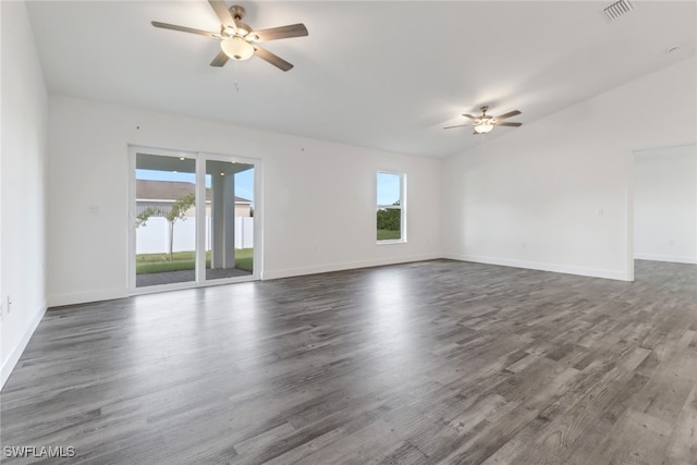 empty room featuring ceiling fan, lofted ceiling, and dark hardwood / wood-style floors