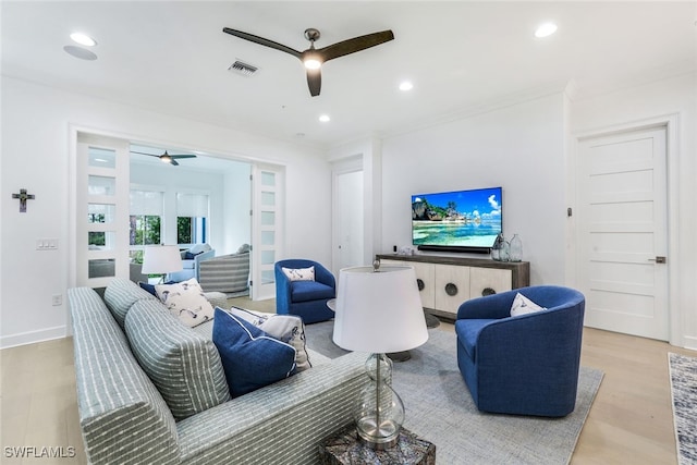 living room featuring light hardwood / wood-style flooring and ceiling fan