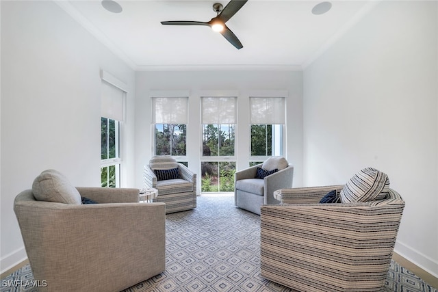 living room with ceiling fan and crown molding