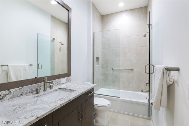 full bathroom with shower / bath combination with glass door, vanity, toilet, and tile patterned floors