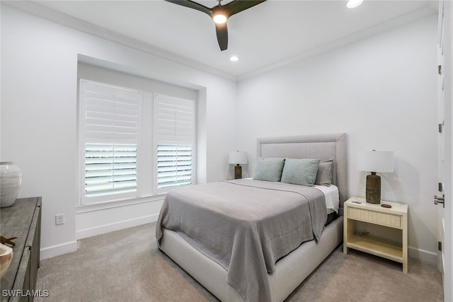 bedroom featuring crown molding, light colored carpet, and ceiling fan