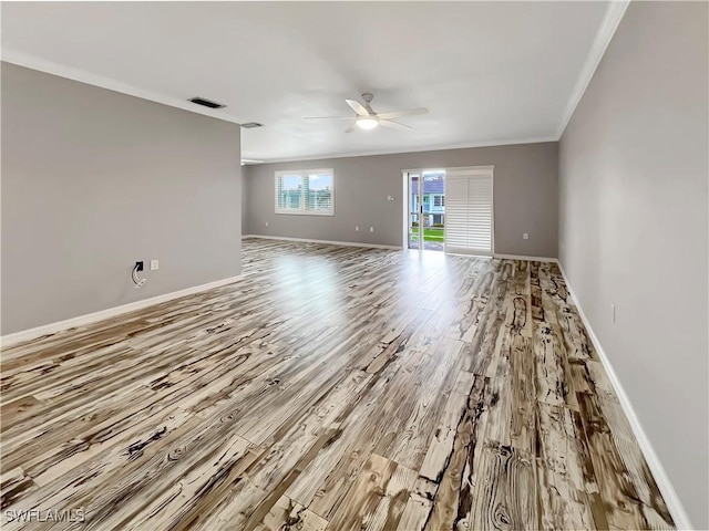 spare room featuring ceiling fan, light hardwood / wood-style floors, and ornamental molding