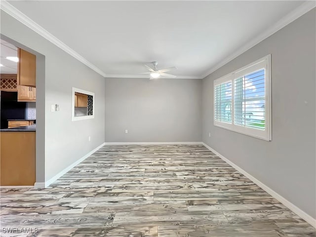 empty room featuring hardwood / wood-style flooring, ceiling fan, and ornamental molding