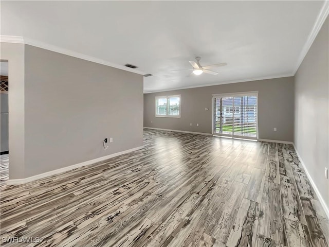 empty room with wood-type flooring, ceiling fan, and crown molding