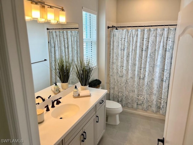 full bathroom featuring toilet, tile patterned floors, vanity, and shower / tub combo with curtain