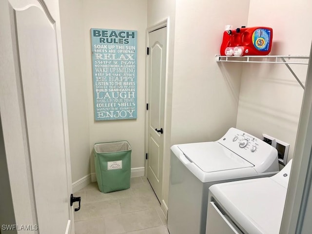 washroom with light tile patterned flooring and washing machine and clothes dryer