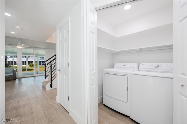 laundry area with washer and clothes dryer, light wood-type flooring, and ceiling fan