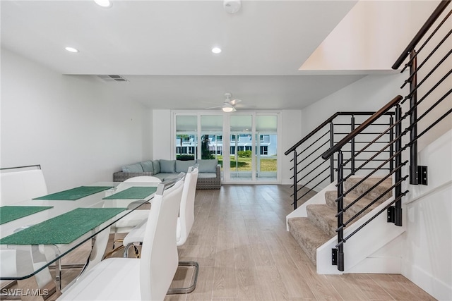 dining room with light wood-type flooring and floor to ceiling windows