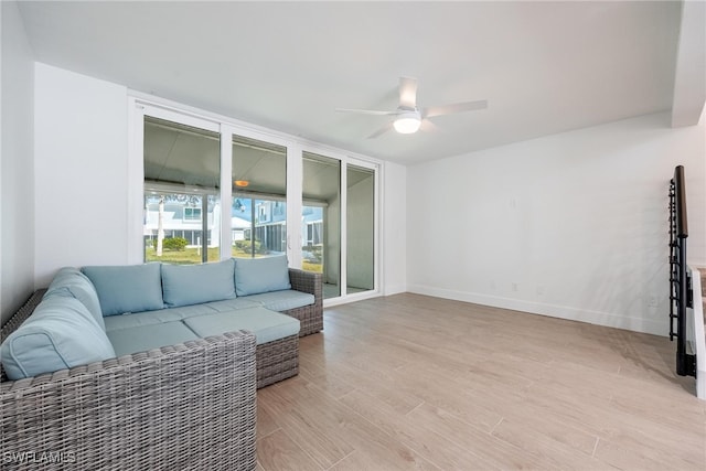 living room featuring ceiling fan and light wood-type flooring