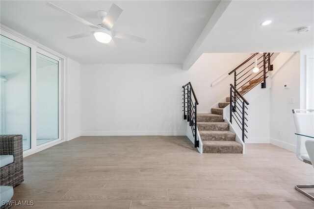 interior space featuring wood-type flooring and ceiling fan