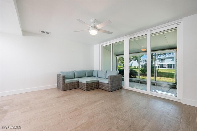 unfurnished living room with light hardwood / wood-style flooring and ceiling fan