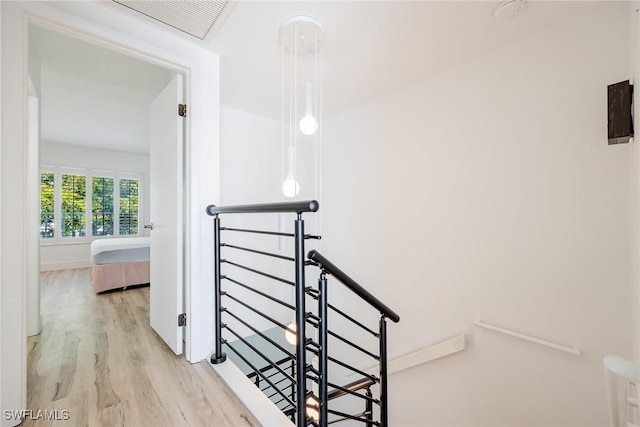 stairway with hardwood / wood-style flooring