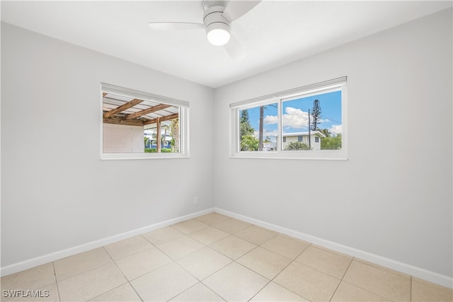 unfurnished room with ceiling fan and light tile patterned floors