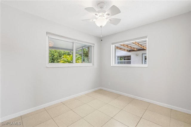 spare room featuring light tile patterned floors and ceiling fan