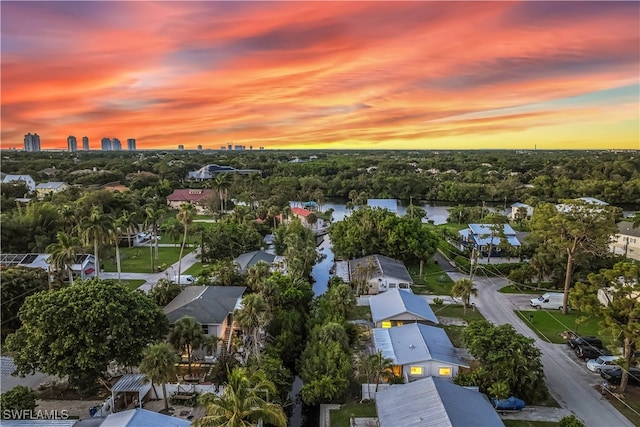 aerial view at dusk with a water view