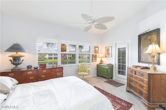 bedroom with ceiling fan, vaulted ceiling, and light hardwood / wood-style floors