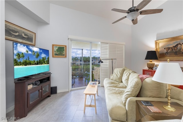 living room with light hardwood / wood-style floors and ceiling fan