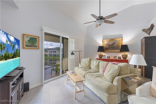 living room featuring light hardwood / wood-style flooring, ceiling fan, and vaulted ceiling