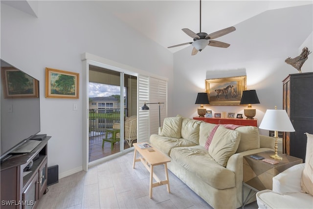 living room featuring light hardwood / wood-style floors, ceiling fan, and vaulted ceiling