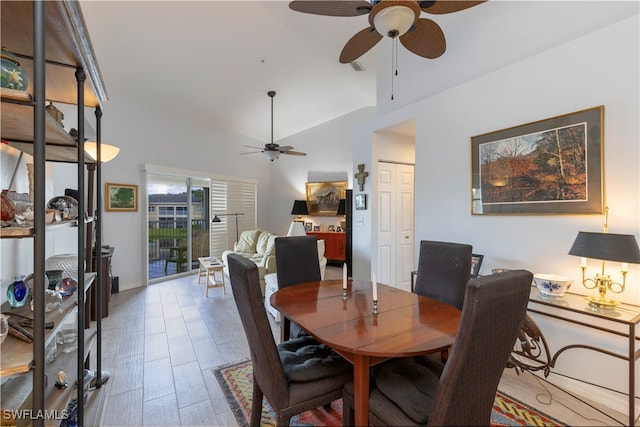 dining space with vaulted ceiling, hardwood / wood-style flooring, and ceiling fan