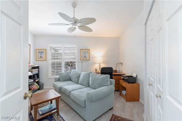 living room with ceiling fan and light wood-type flooring