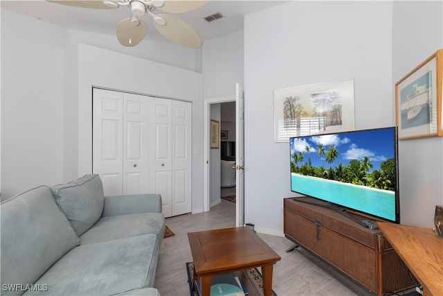 living room with light wood-type flooring and ceiling fan