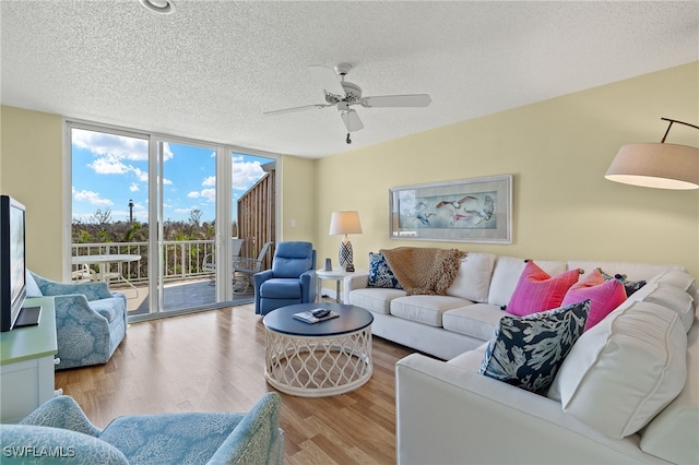 living room with floor to ceiling windows, a textured ceiling, hardwood / wood-style flooring, and ceiling fan