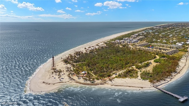 birds eye view of property with a water view and a beach view