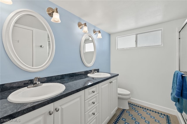 bathroom featuring toilet, vanity, and tile patterned flooring