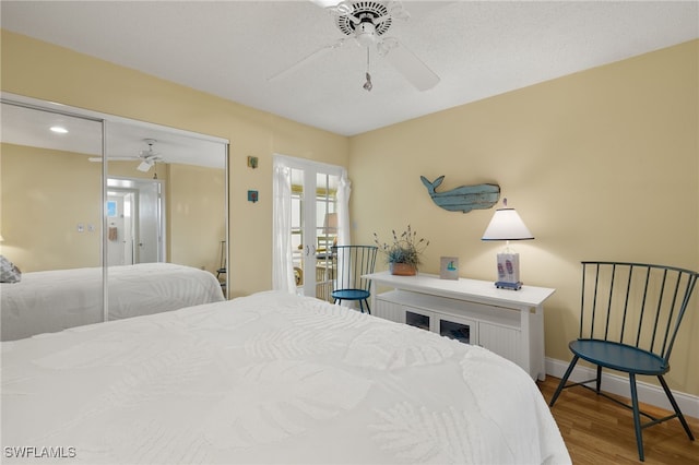 bedroom featuring hardwood / wood-style flooring, ceiling fan, and a closet