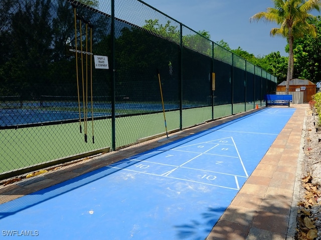 view of property's community with tennis court